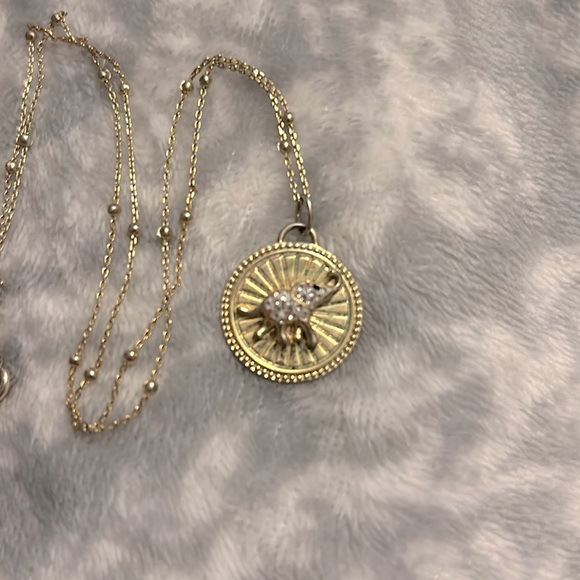 This is a gold elephant necklace with diamonds. - Picture 2 of 4